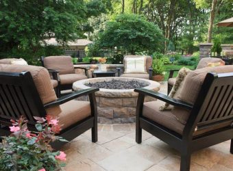 patio with chairs and a firepit at the center